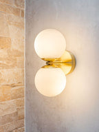 Brass wall light with two opal glass