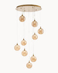 Brass nine light pendant with amber glass